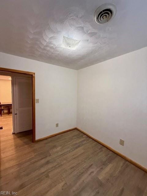 unfurnished room featuring hardwood / wood-style flooring