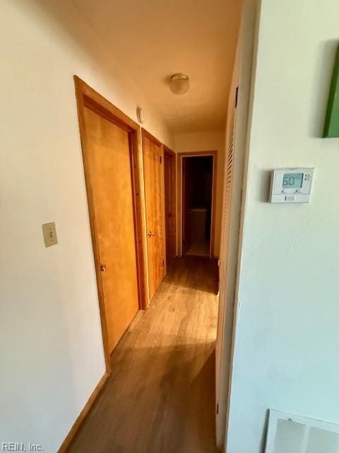 corridor with light hardwood / wood-style floors