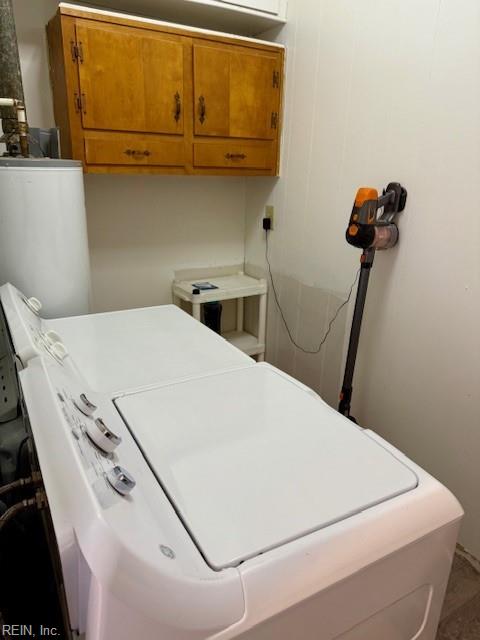 laundry room with cabinets and gas water heater