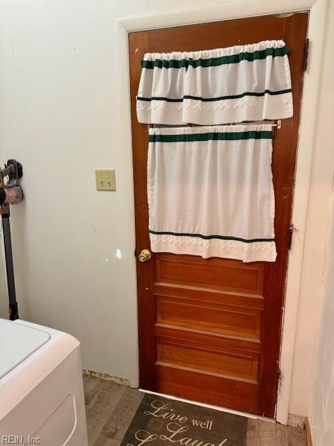 bathroom with washer / clothes dryer and wood-type flooring