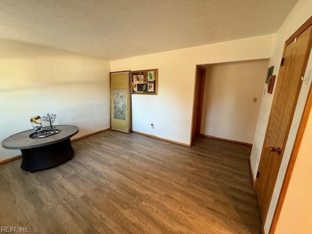 spare room featuring dark wood-type flooring