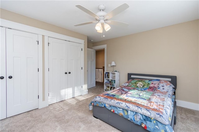 bedroom featuring light carpet, a closet, and ceiling fan