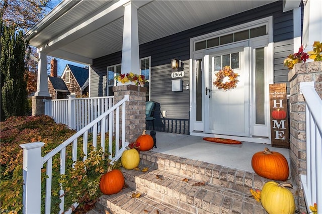 view of exterior entry with covered porch