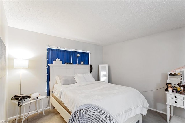 carpeted bedroom with a textured ceiling