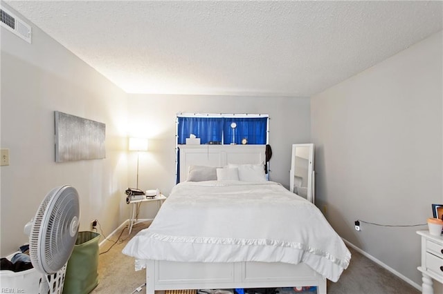 bedroom featuring carpet flooring and a textured ceiling