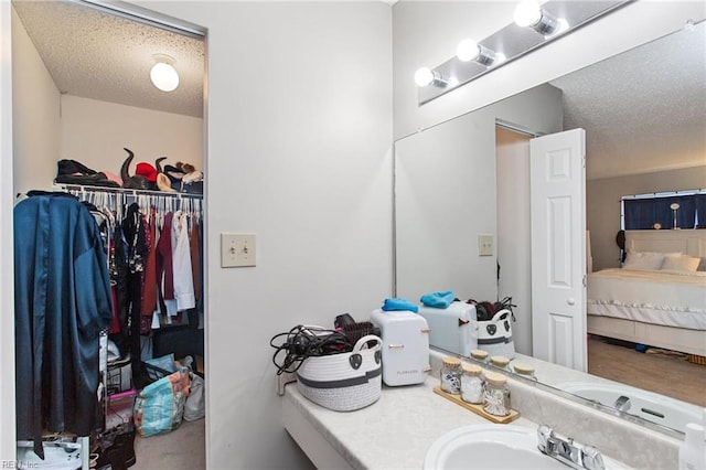 bathroom featuring vanity and a textured ceiling