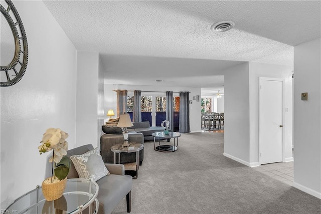 living room featuring light carpet and a textured ceiling