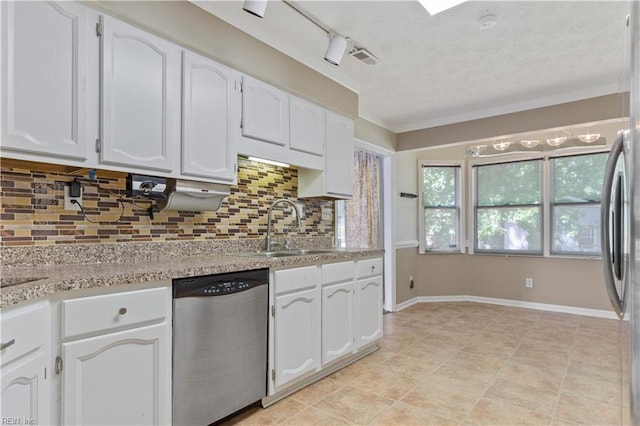 kitchen featuring white cabinets, dishwasher, sink, and tasteful backsplash