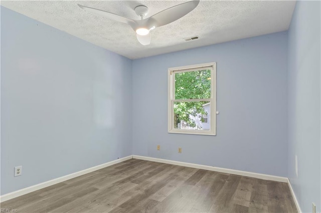 empty room with ceiling fan, a textured ceiling, and hardwood / wood-style flooring