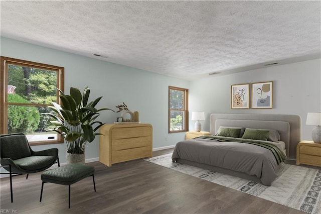 bedroom featuring wood-type flooring and a textured ceiling