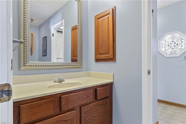 bathroom with vanity and a textured ceiling