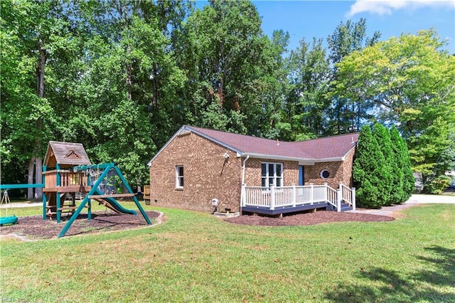 view of home's exterior featuring a playground, a wooden deck, and a lawn