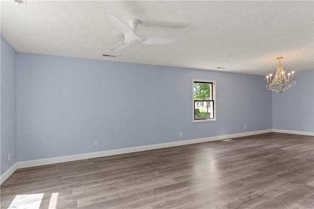 unfurnished room featuring hardwood / wood-style floors and ceiling fan with notable chandelier