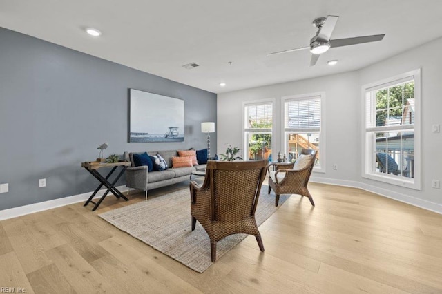 living room with ceiling fan and light wood-type flooring