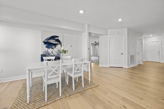 dining space featuring light wood-type flooring and ceiling fan