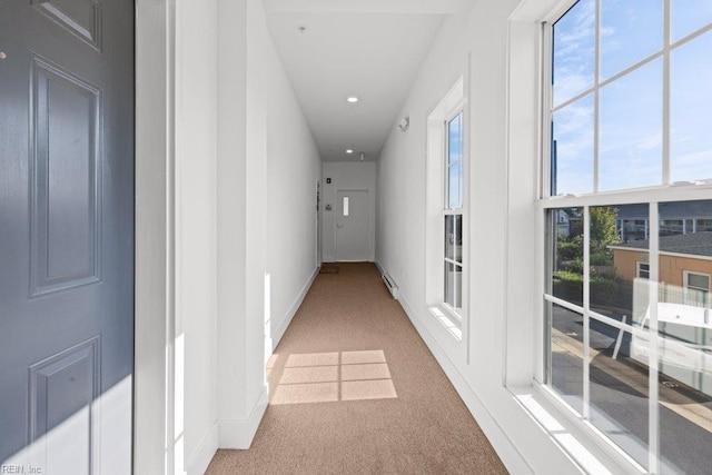 hall featuring carpet floors and baseboard heating