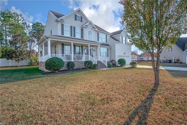 view of front of property with a front yard, a porch, and a garage