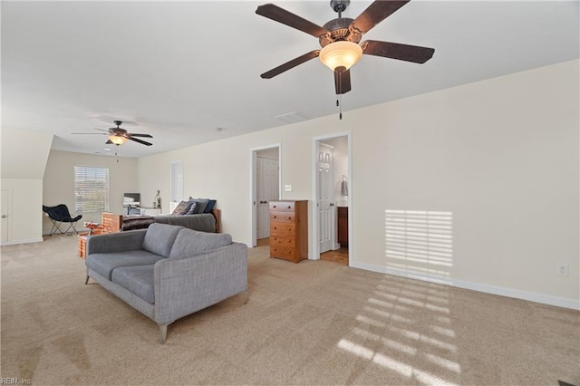 carpeted living room with ceiling fan