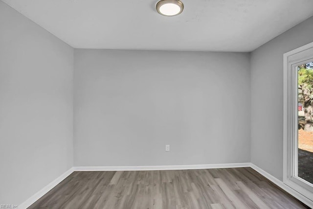 unfurnished room with hardwood / wood-style flooring