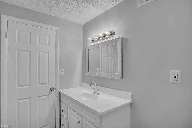 bathroom with vanity and a textured ceiling