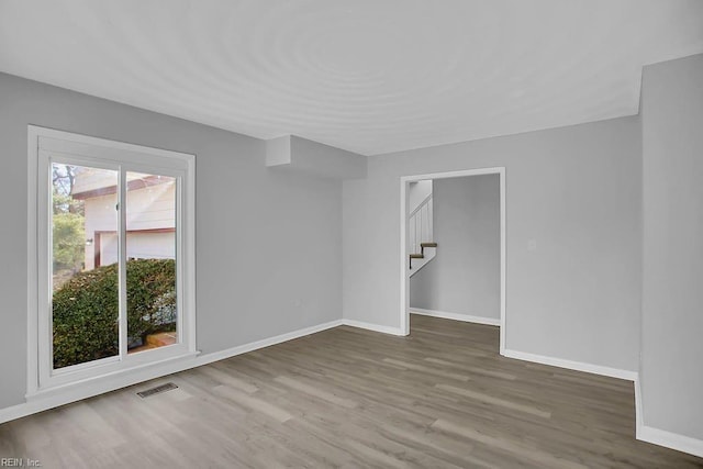 spare room featuring hardwood / wood-style floors