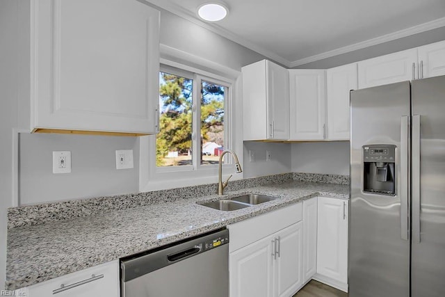 kitchen featuring white cabinets, crown molding, sink, light stone countertops, and appliances with stainless steel finishes