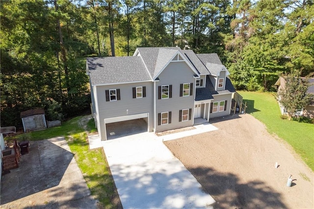 view of front of home featuring a front yard and a garage