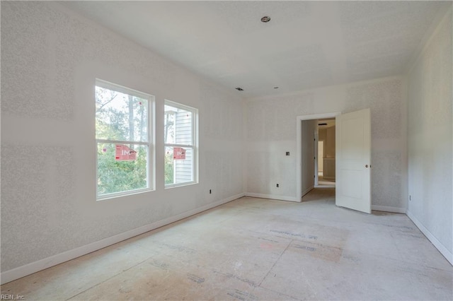 spare room featuring baseboards