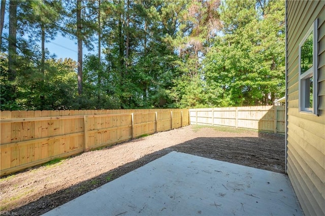 view of yard featuring a patio area and a fenced backyard