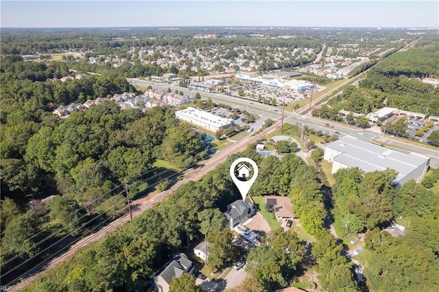 drone / aerial view featuring a wooded view