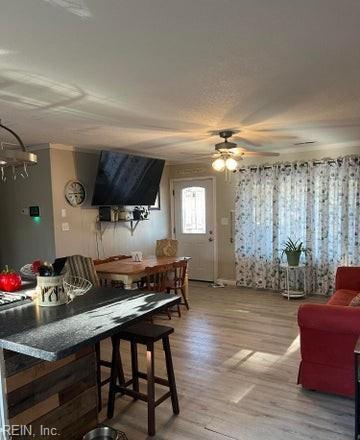 dining area featuring light wood-type flooring and ceiling fan