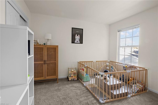 carpeted bedroom featuring a crib