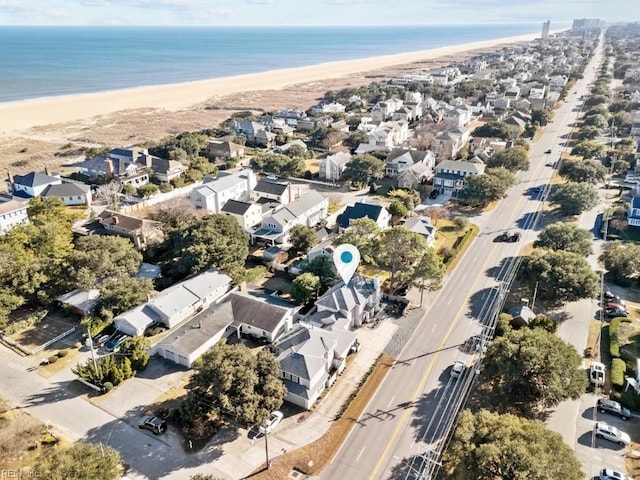 drone / aerial view with a water view and a beach view