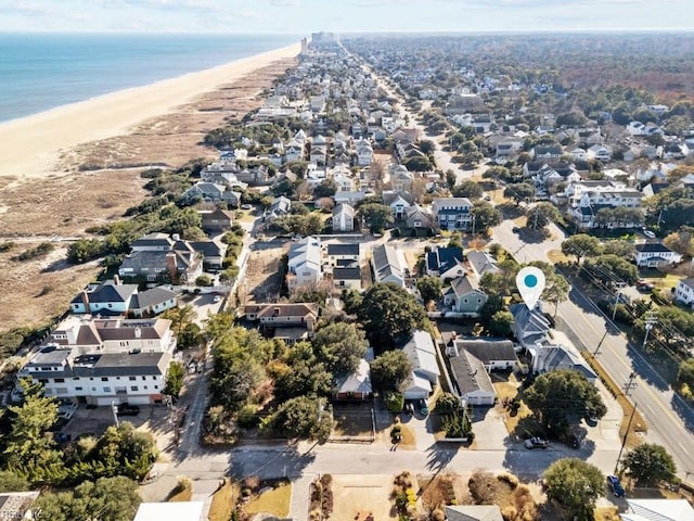 drone / aerial view featuring a beach view and a water view