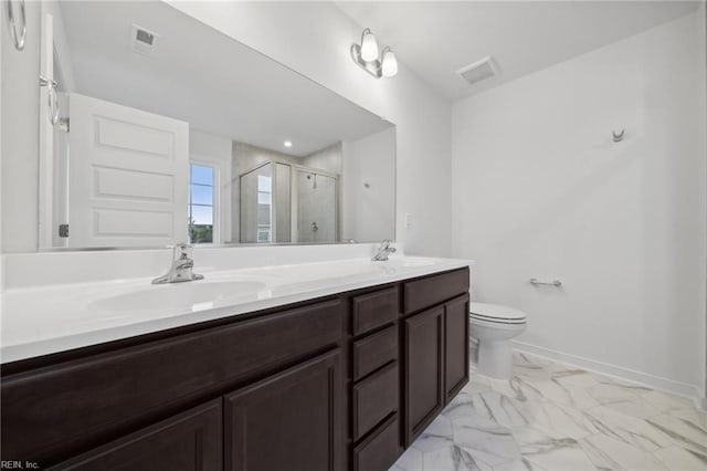 bathroom featuring vanity, a shower with shower door, and toilet