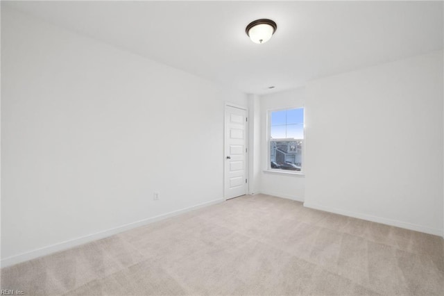 unfurnished room with light colored carpet