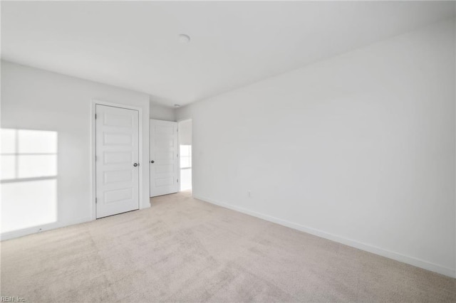 empty room with light colored carpet