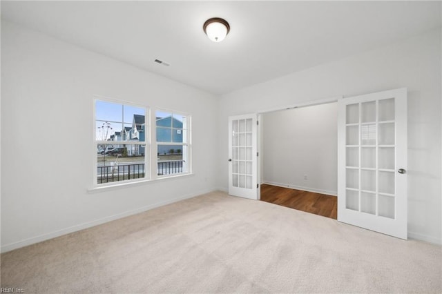 carpeted empty room with french doors