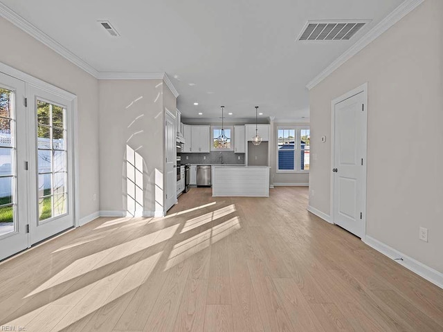 unfurnished living room featuring light wood-type flooring and crown molding