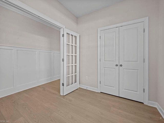 unfurnished bedroom with a closet and light hardwood / wood-style floors