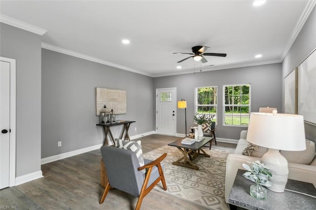 living room featuring crown molding, ceiling fan, and dark hardwood / wood-style floors