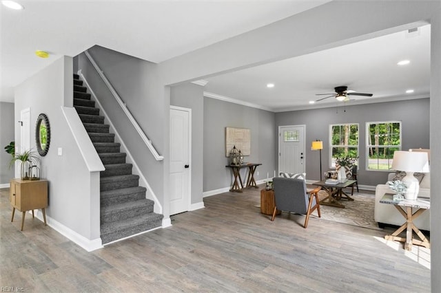 interior space with ceiling fan, crown molding, and hardwood / wood-style flooring