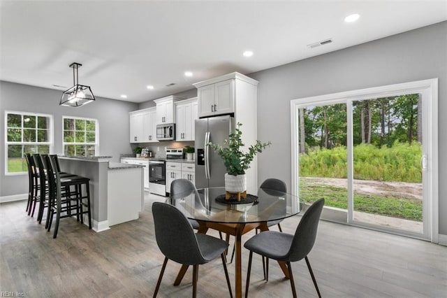 dining room featuring hardwood / wood-style flooring and a wealth of natural light