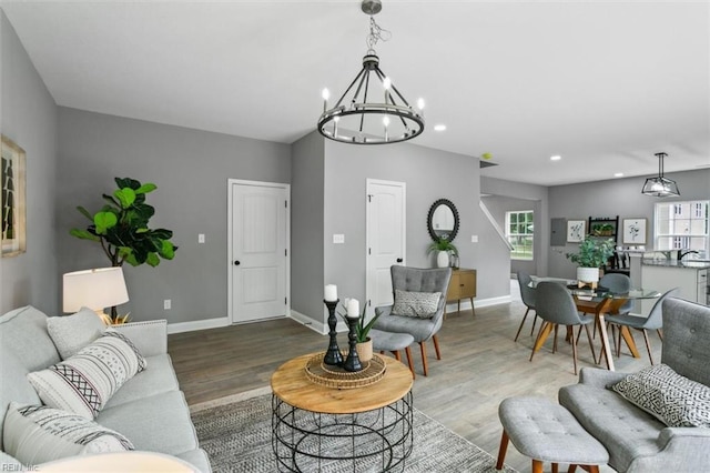 living room featuring an inviting chandelier and hardwood / wood-style flooring