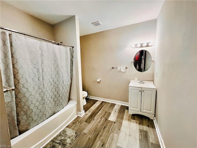 full bathroom with vanity, toilet, wood-type flooring, and shower / tub combo with curtain