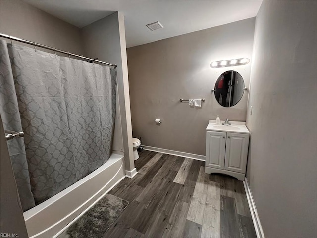 full bathroom with hardwood / wood-style floors, vanity, toilet, and shower / bathtub combination with curtain