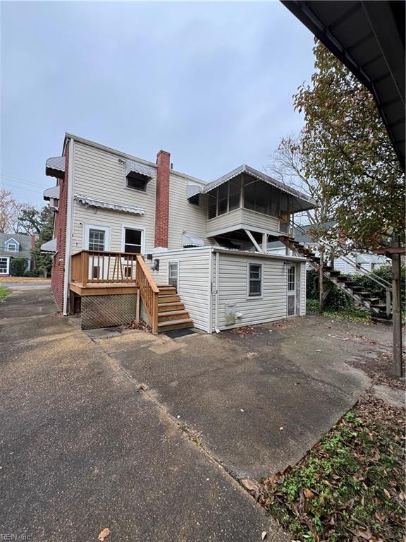 rear view of property featuring a deck