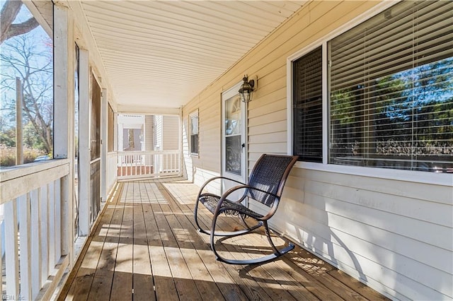 wooden terrace featuring covered porch