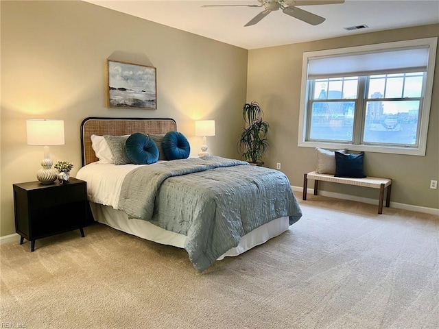 bedroom with ceiling fan and light carpet