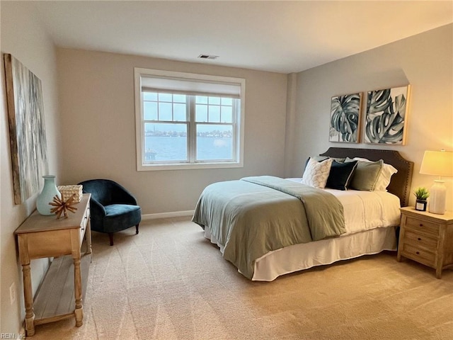 bedroom featuring light colored carpet